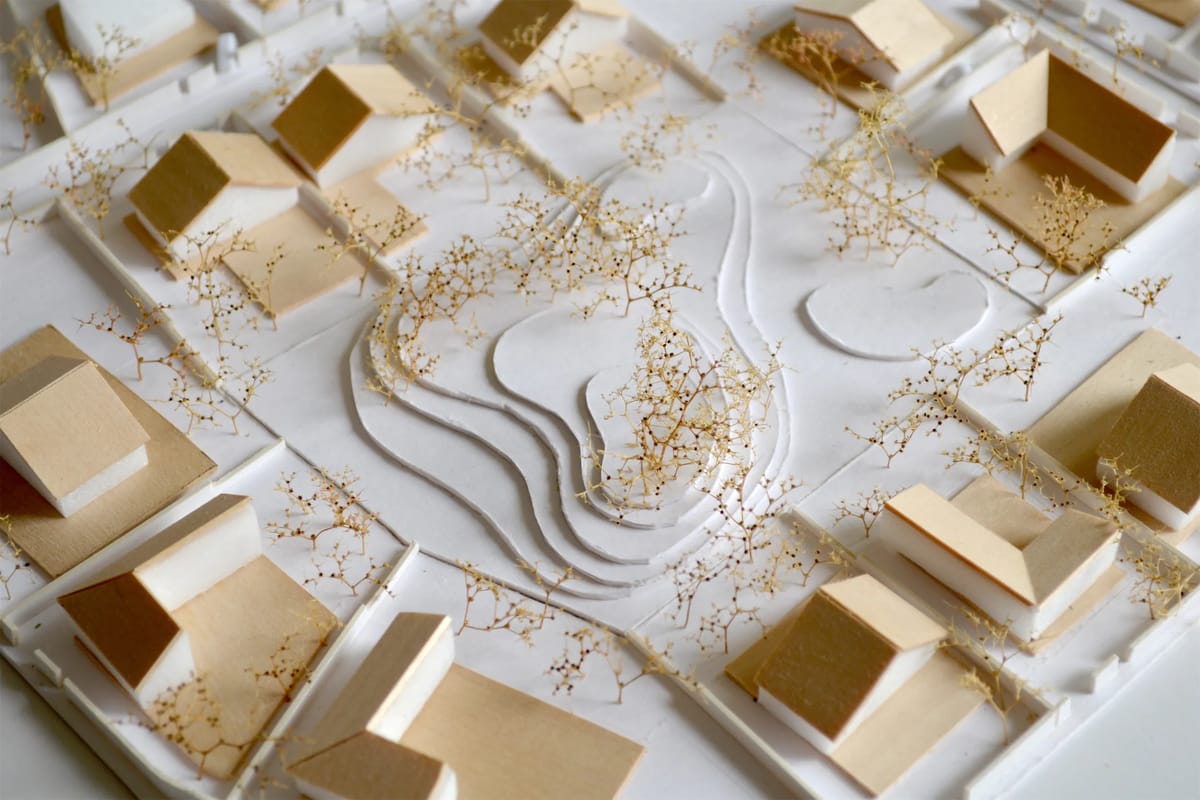 Close-up of the model with wooden house volumes, contour layers and dried-flower trees
