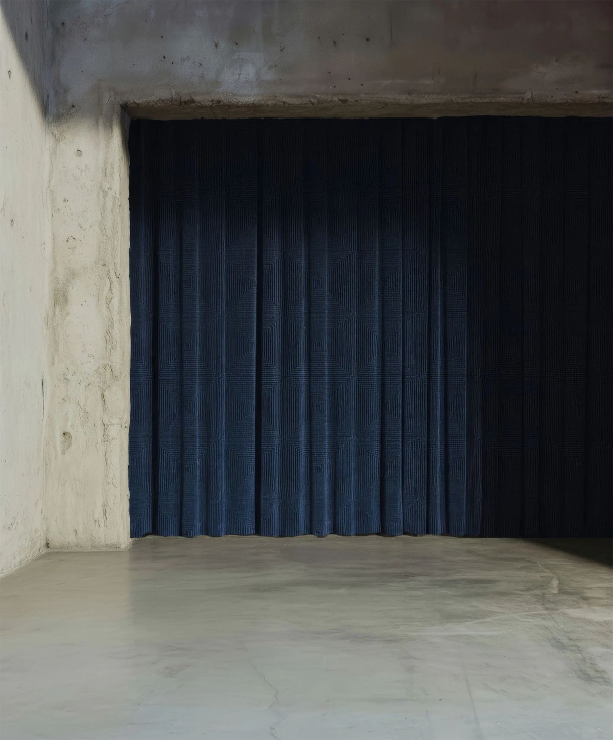 Render of a dark blue patterned curtain inside a raw concrete room with a polished floor