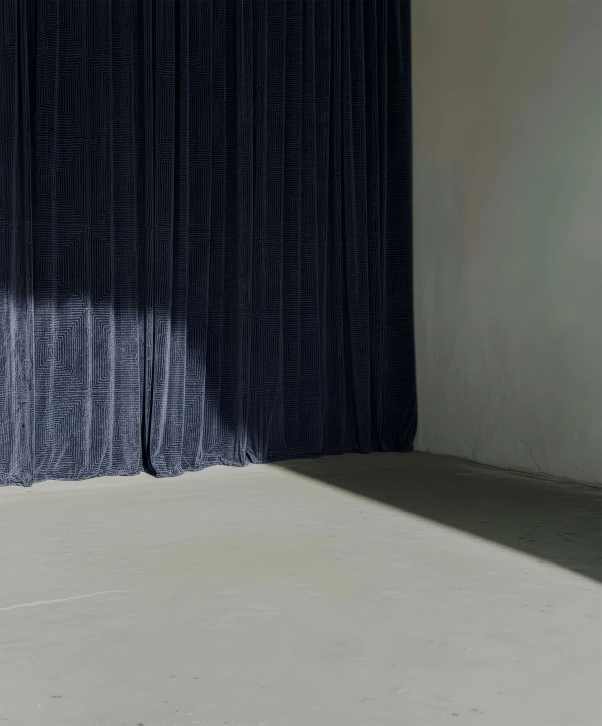 Render of a velvety blue-grey curtain in a bright corner, sunlight cutting across the floor